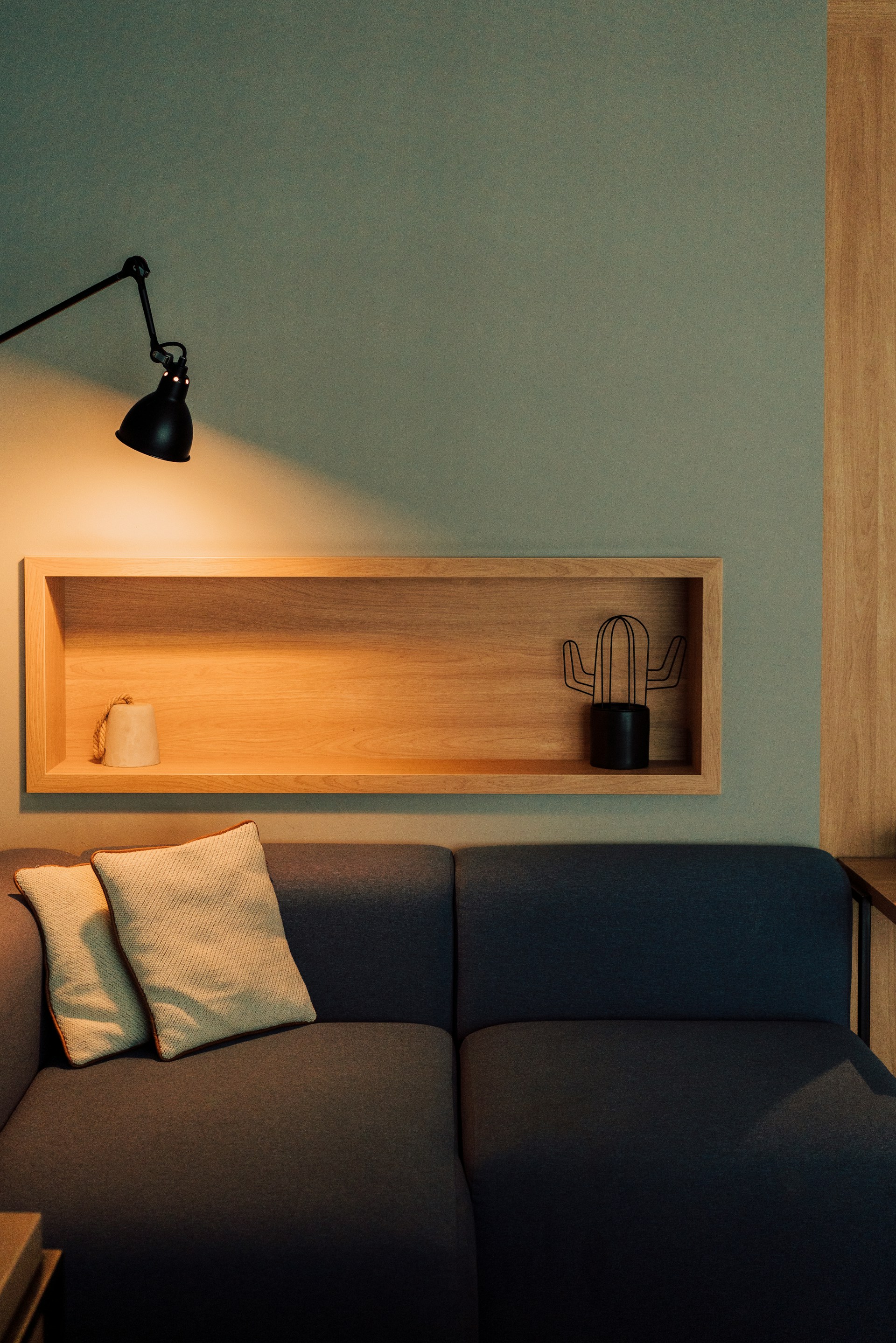 A timber niche set into a green wall