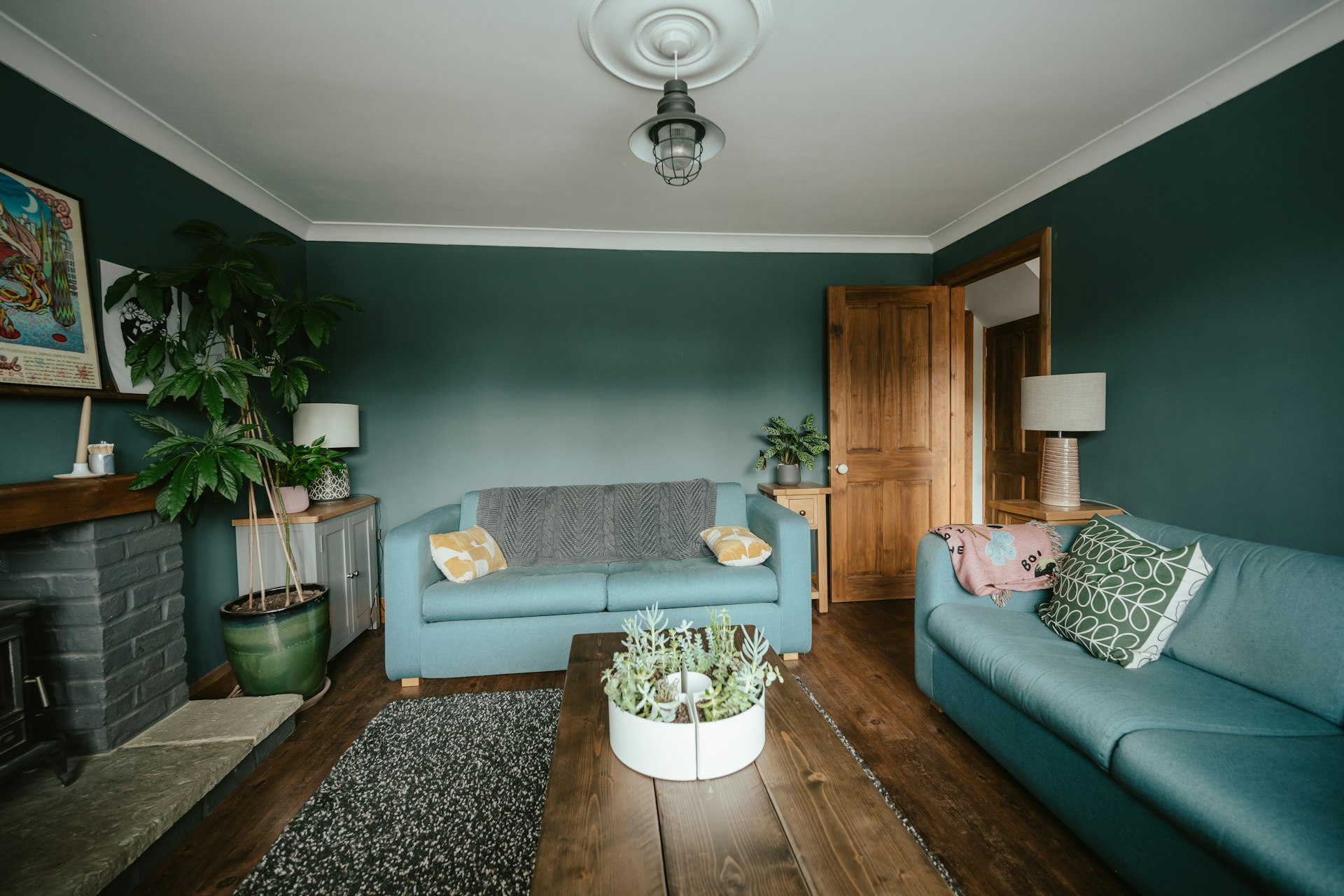 A green sitting room with a blue sofa