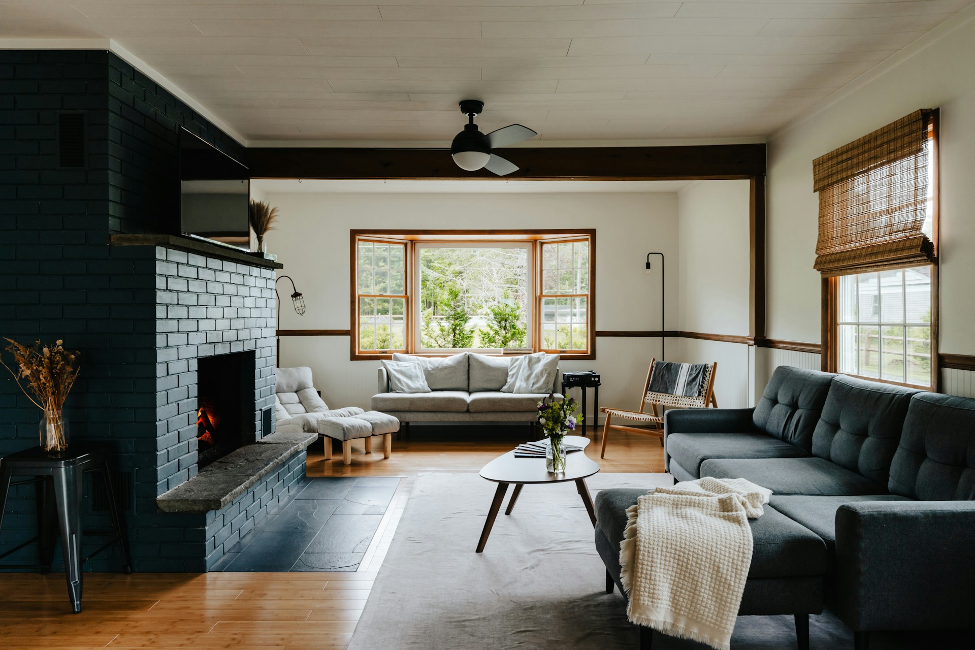A family room with a brick fireplace